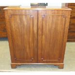 An antique mahogany low bookcase, having a pair of doors and shelved interior, on bracket feet,