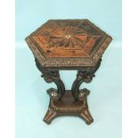 A Ceylonese specimen wood and ebony table, the hexagonal top with carved and moulded border