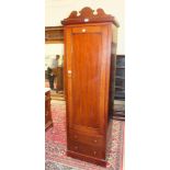 A mahogany single-door hanging wardrobe, the panelled door above two drawers, 60cm wide, 195cm