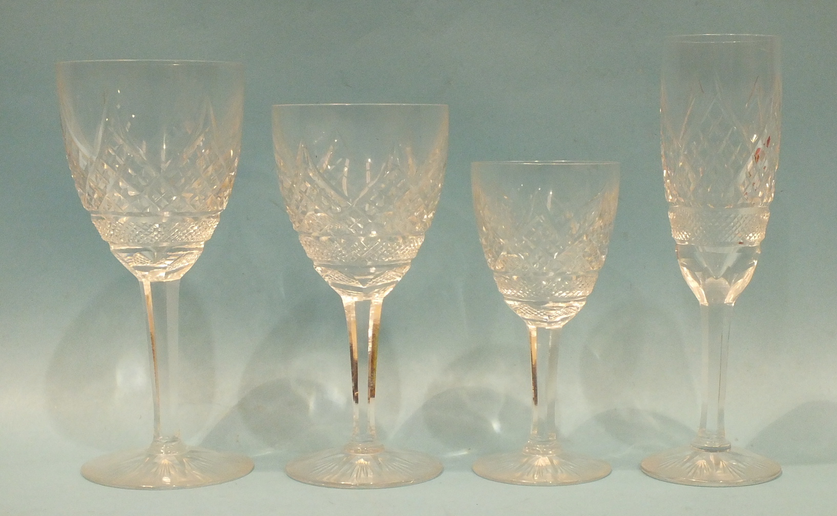 A part-suite of heavy cut-glass drinking glasses: six large wine glasses, six small wine glasses,