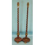 A pair of 20th century painted wood and gilt standard lamp columns of spiral twist form, on circular