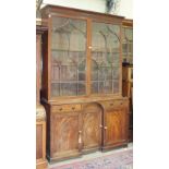 A Late-Georgian mahogany bookcase, the moulded cornice above a pair of Gothic arch astragal-glazed