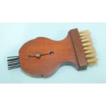 A Victorian or Edwardian walnut brush or comb cleaner with retractable metal tines, 8 x 4cm.
