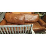 A brown leather three-seater settee, 230cm wide, complies with fire regulations.