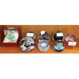 Seven Caithness glass paperweights: Extravaganza, Goldrush, Petunias, Triple Crown, Miniature