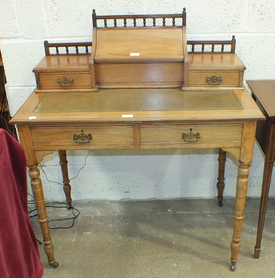 A late Victorian walnut writing desk, the galleried super-structure with two small drawers and a