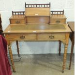 A late Victorian walnut writing desk, the galleried super-structure with two small drawers and a