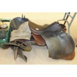 Four leather saddles and other items.
