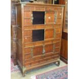 A modern oriental lacquered hardwood sideboard, having an arrangement of seven drawers and two