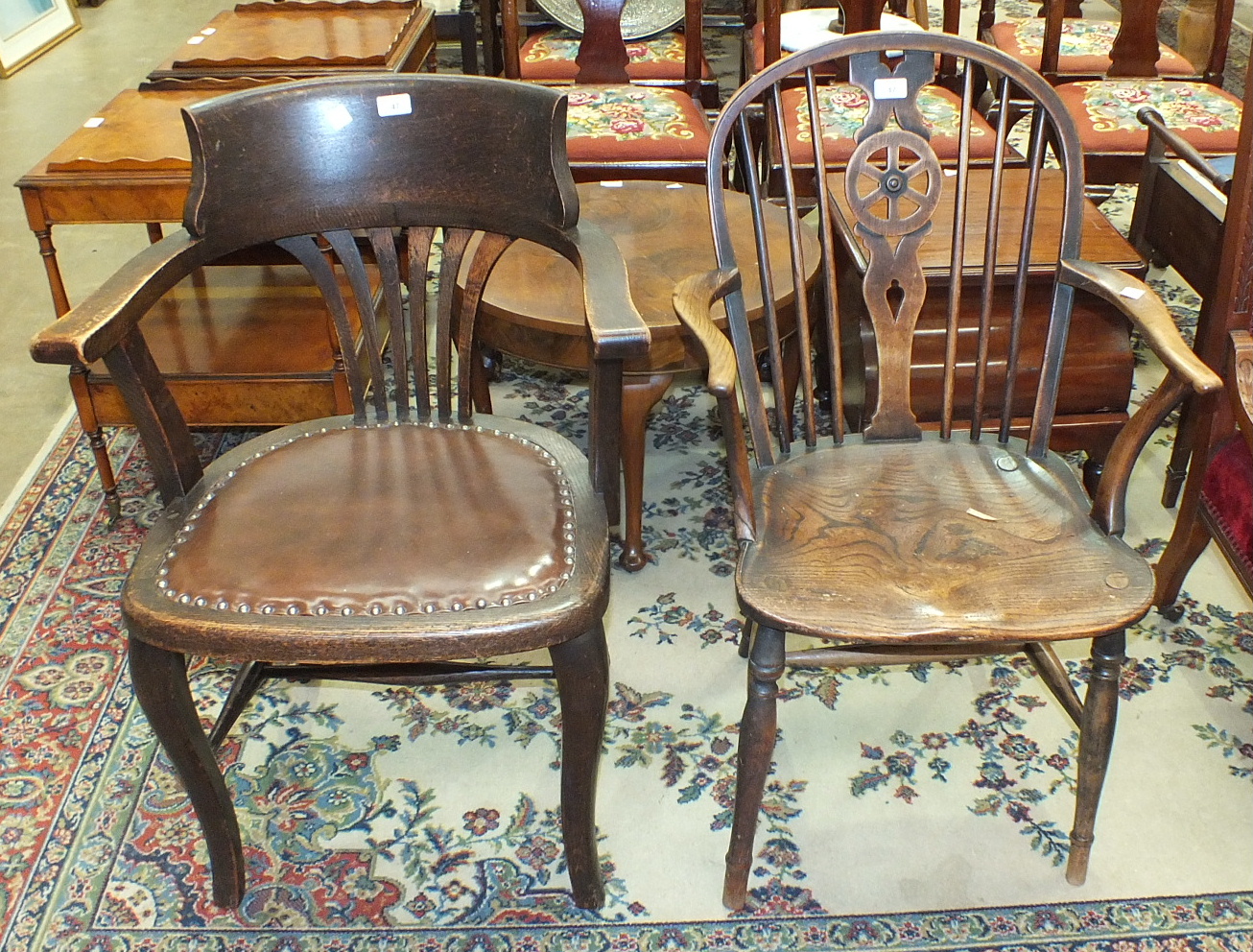 An elm and beech wheelback armchair and a stained wood office chair, (2).