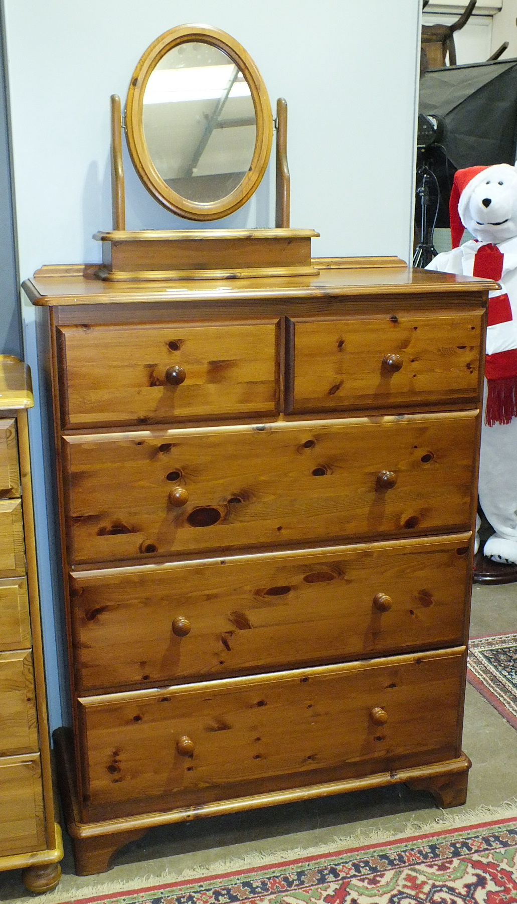 A modern pine chest of two short and three long drawers, 95cm wide, 128cm high and a dressing glass,