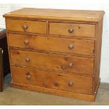 A stripped pine rectangular chest of two short and three long drawers, 104cm wide.