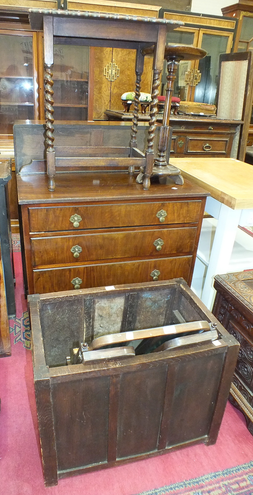 A panelled oak log box, a walnut four drawer chest and a dressing glass.