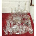 Two glass decanters and stoppers, a cut glass water jug, various drinking glasses and other