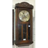 An oak cased striking wall clock, 76cm and an oak framed rectangular bevelled edge mirror with the