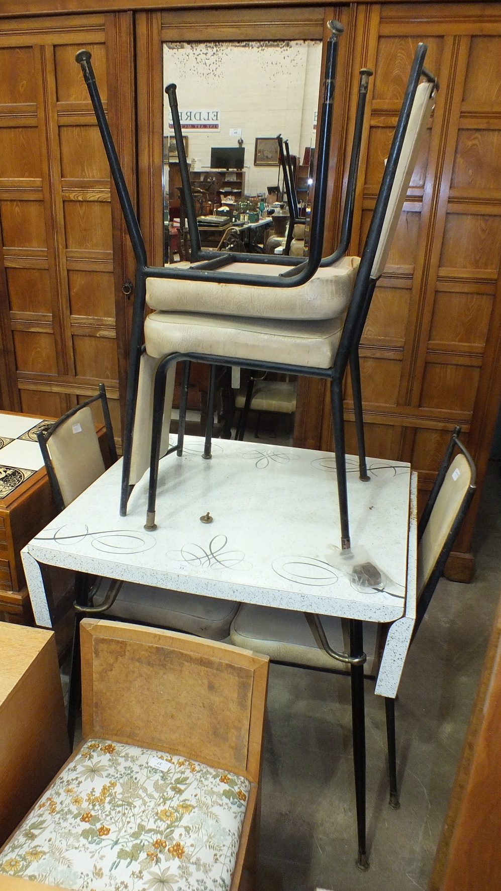 A 1960's Formica top drop leaf kitchen table on black tubular tapering legs, 129.5 x 65cm open and