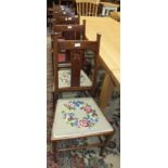 A set of six oak framed dining chairs with centre splats and padded seats on square tapering front