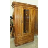 A satin walnut single door wardrobe, the moulded cornice above a bevelled mirrored door and base