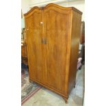 A walnut two-door wardrobe, 106cm wide and a matching dressing table, (2).