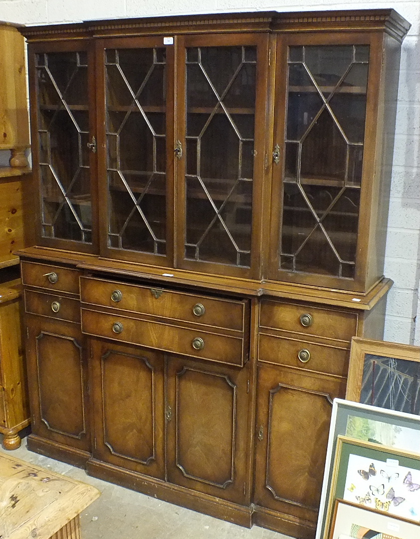 A Georgian-style secretaire/library bookcase by Reprodux, having four astragal-glazed doors over