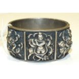 A white metal hinged cuff bangle with three panels representing Indian deities, clasp (a/f), ___2.