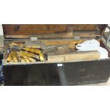 A painted tool box, 92cm wide, containing a collection of hand tools, chisels, saws and a small