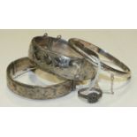 Three silver hinged bangles with engraved decoration and a marcasite-set ring, ___2.1oz, (4).