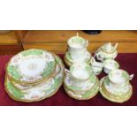 A Coalport ceramic part tea service decorated with gilt, floral sprays and Victoria green panels,