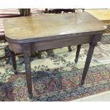 A 19th century mahogany fold-over tea table on turned legs, 91cm wide.