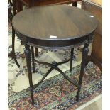 An Edwardian mahogany circular occasional table on turned and reeded legs joined by stretchers, 61cm