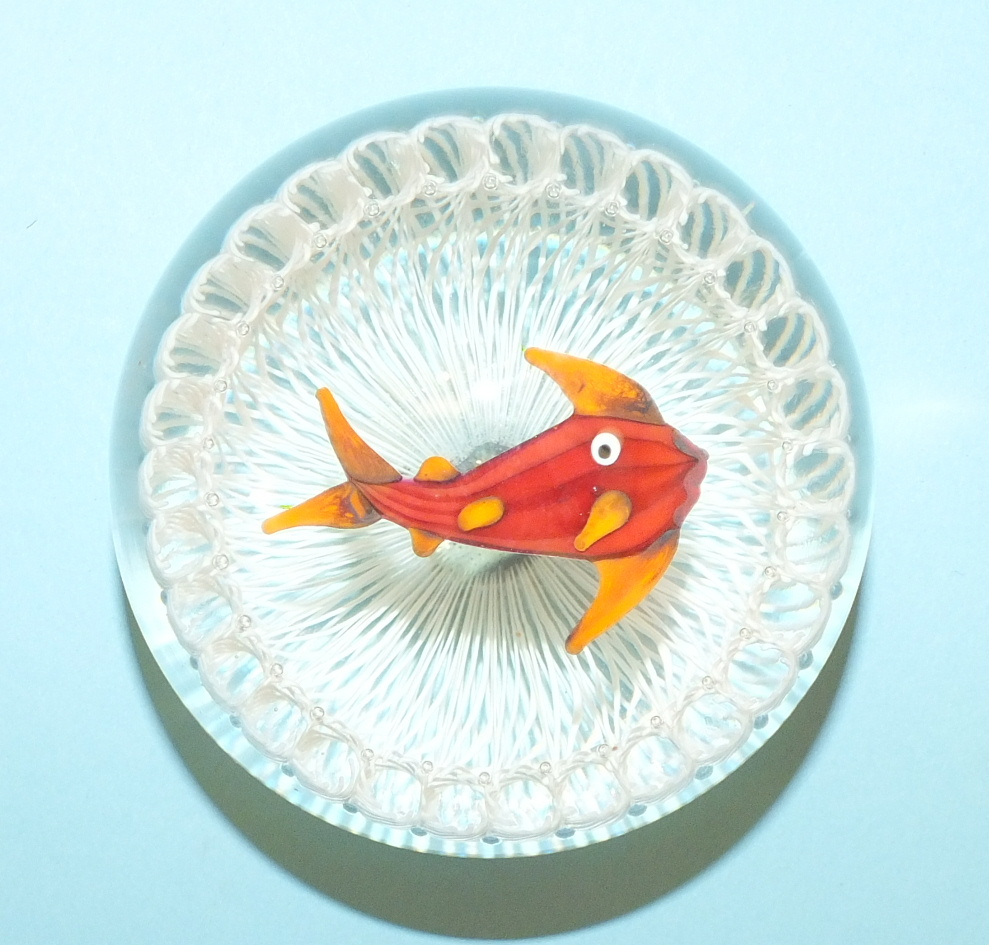 A glass paperweight in the style of Paul Ysart, decorated with a fish on a white lattice ground, 8cm