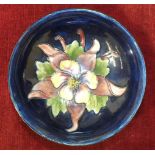 A Moorcroft Pottery blue-glazed bowl, the interior decorated with Columbine pattern to the centre,