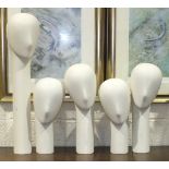 A collection of five glass fibre millinery mannequins with weighted bases, comprising: one straight,