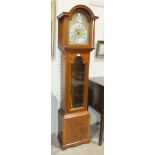 A modern mahogany finish long case clock, the dial with Roman numerals and chiming movement by