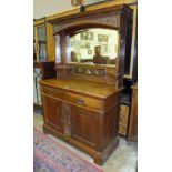 An early-20th century oak sideboard in the Art Nouveau style, the mirrored back with copper panel of