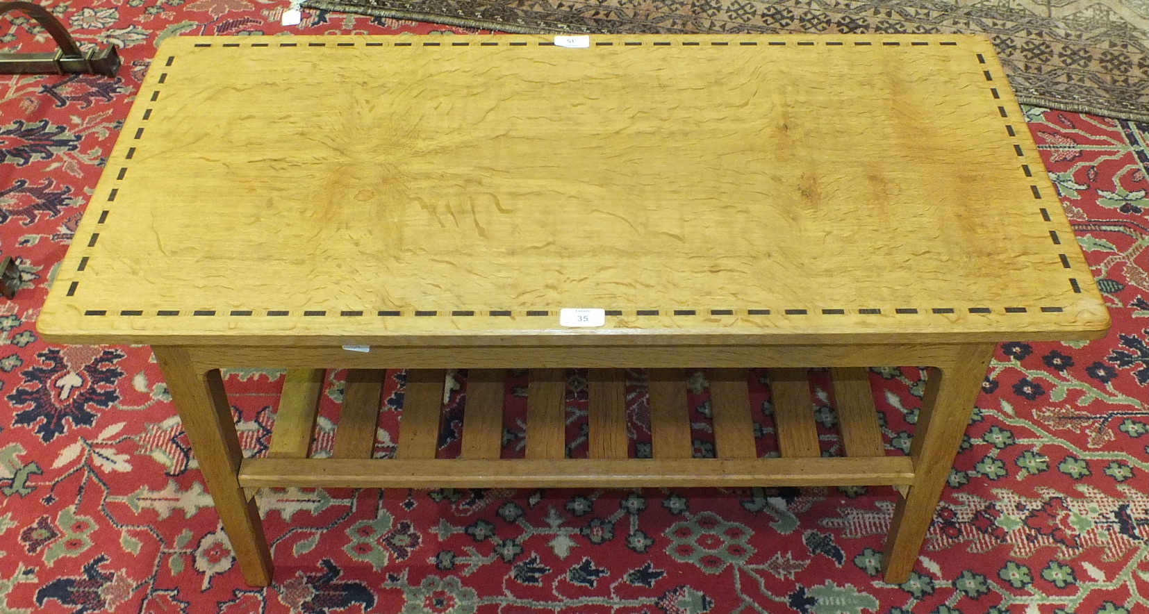 A craftsman-made oak two-tier coffee table, the rectangular inlaid top on chamfered square legs