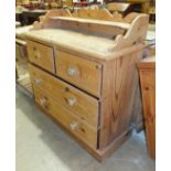 A stripped pine chest, the low back above a rectangular top, two short and two long drawers, on