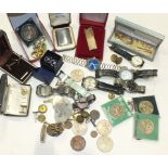A collection of various wrist watches, lighters, coins and miscellaneous items.
