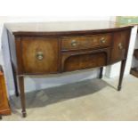A Georgian mahogany bow-fronted sideboard fitted with two central drawers, flanked by cupboard