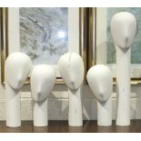 A collection of five glass fibre millinery mannequins with weighted bases, comprising: one straight,