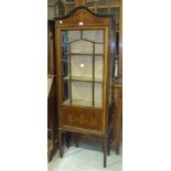 An Edwardian inlaid mahogany display cabinet fitted with a single glazed door and glazed sides, on