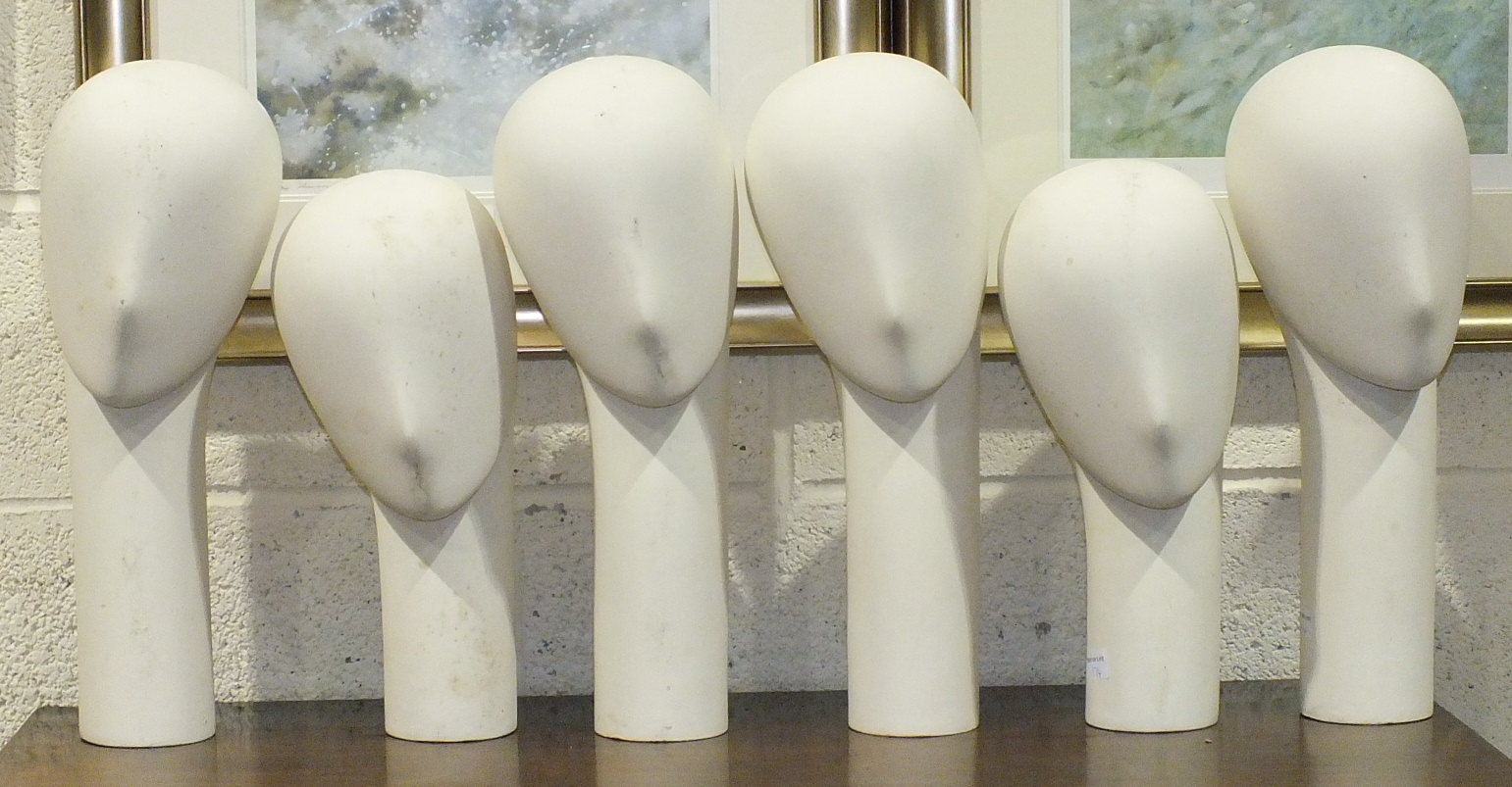 A collection of six glass fibre millinery mannequins with weighted bases, comprising: three