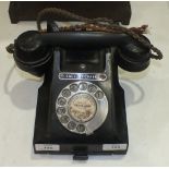 A black Bakelite telephone, No.312F S57/3A.