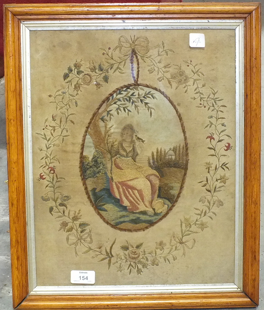 An 18th century embroidered silk-work and stump-work picture of a young woman seated beneath a