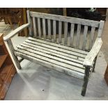 A weathered teak slatted garden bench, 127cm wide.