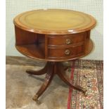 A 20th century mahogany drum table in the Regency style, the circular top inset with leather above