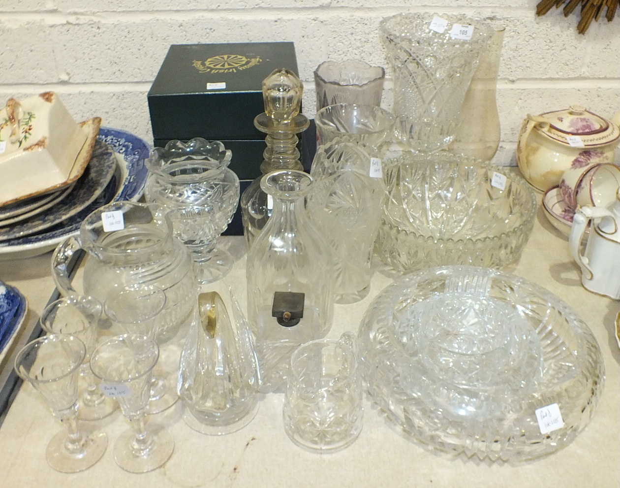 A collection of cut and other glassware, including vases, decanters, bowls, wine and drinking