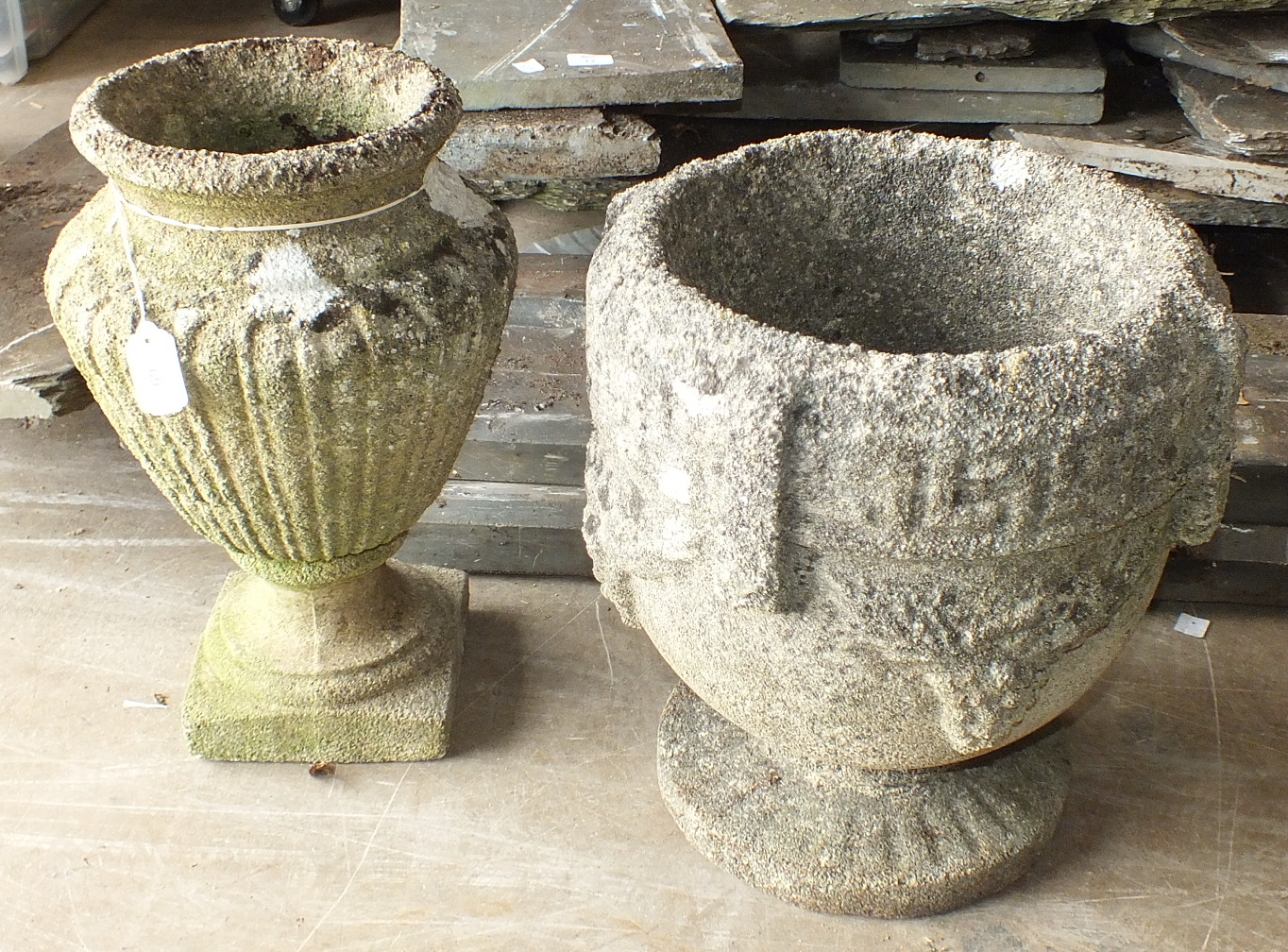 A cast concrete garden urn, 44cm high, 26cm diameter and one other, 40cm high, 33cm diameter, (2).