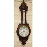 W H May, Nottingham, a carved stained mahogany banjo aneroid barometer/thermometer, 90cm high.