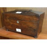 A 19th century rosewood tea caddy of sarcophagus shape, the interior with two containers and